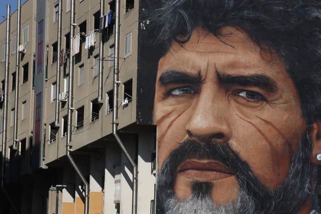 A giant mural of soccer legend Diego Maradona adorns the side of a building, in Naples, southern Italy. (AP Photo/Alessandra Tarantino)