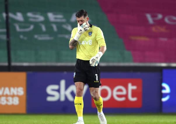 Sheffield Wednesday goalkeeper Keiren Westwood leaves the Liberty Stadium pitch after 'tewaking' his groin, making him a doubt for Saturday's match with Stoke. Picture: David Davies/PA