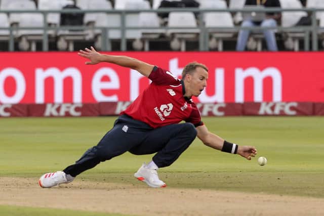 England bowler Tom Curran fields the ball of his bowling during a T20 cricket match between South Africa and England in Cape Town South Africa. (AP Photo/Halden Krog)