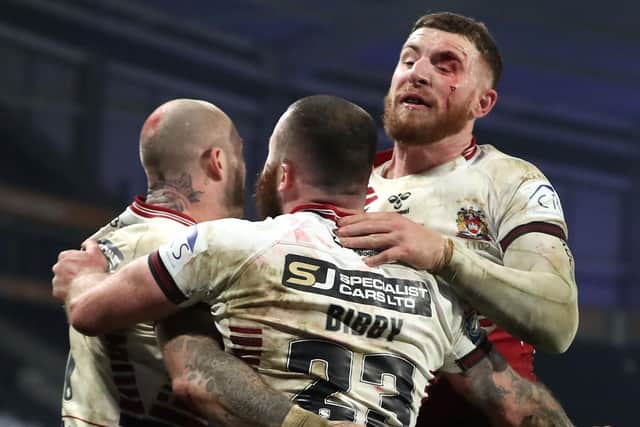 Wigan Warriors Jake Bibby (centre) celebrates scoring his sides first try during the Betfred Super League Grand Final at the KCOM Stadium, Hull. (Pictures: Martin Rickett/PA Wire)