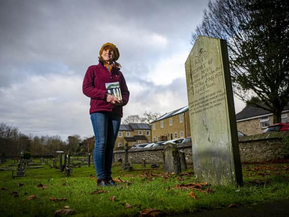Sarah Lister beside the grave of navvy John Jones, who was just 17 when he died working on the railway