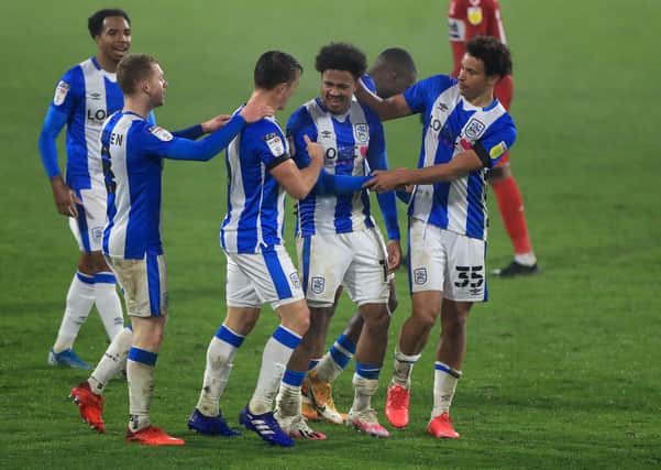 Match-winner: Huddersfield Town's Josh Koroma, centre, celebrates. Pictures: PA