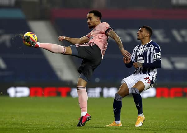 Debutant: Sheffield United's Kean Bryan clears from West Bromwich Albion's Karlan Ahearne-Grant. Picture: PA