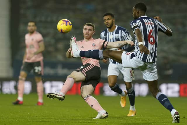 TOUGH TIMES: John Fleck battles with Semi Ajayi at The Hawthorns. Picture: Andrew Yates/Sportimage