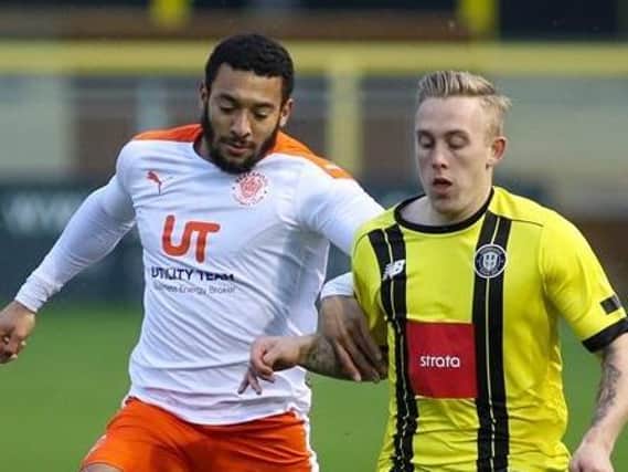 Harrogate Town's Calvin Miller is challenged by Blackpool's Keshi Anderson. Pictures: Matt Kirkham