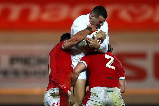 Squeezed out: England's Jonny May is tackled by Johnny Williams and Ryan Elias. (Photo by Michael Steele/Getty Images)