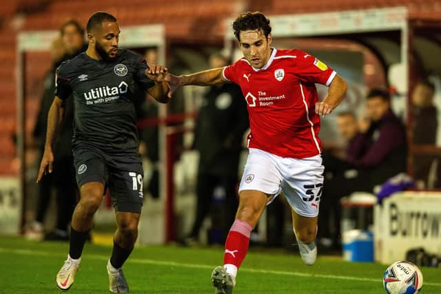 Matty James holds off Bryan Mbeumo in the recent clash against Brentford at Oakwell.  Picture: Bruce Rollinson