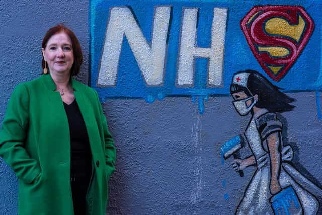 Debbie in front of a mural celebrating NHS workers. Photo: Ernesto Rogata