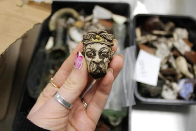 This moustachioed figure, part of a decorated clay pipe bowl, has been unearthed as part of the dig on the Trinity burial ground in Hull Picture: Highways England