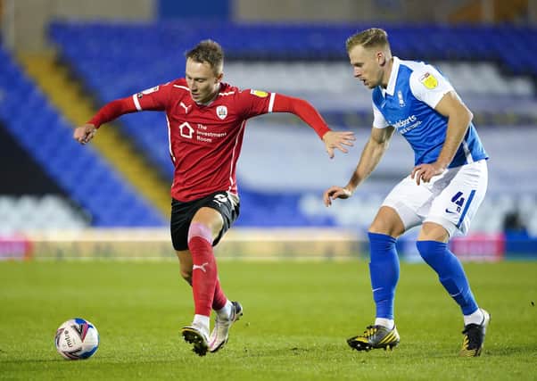Birmingham City's Marc Roberts (right) and Barnsley's Cauley Woodrow battle for the ball at St Andrew's Trillion Trophy Stadium. Picture: Zac Goodwin/PA