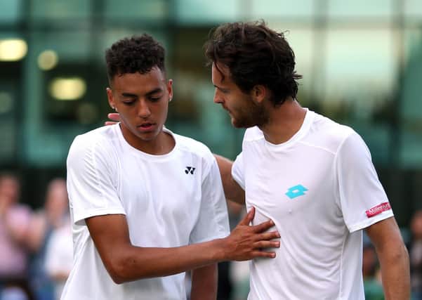 Joao Sousa (right) shakes hands with Paul Jubb after their match on day two of the Wimbledon last year. Picture: Steven Paston/PA