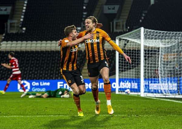 Winner: Hull City substitute Tom Eaves celebrates his goal  with Callum Elder after Doncaster Rovers goalkeeper Joe Lumley fumbled the ball. (Picture: Tony Johnson)