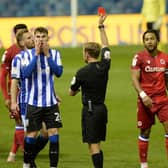 Red card for Owls' Liam Shaw for his tackle on Reading's Omar Richards.   Pictures: Steve Ellis