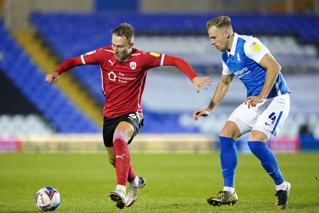 Birmingham City's Marc Roberts (right) and Barnsley's Cauley Woodrow battle for the ball.