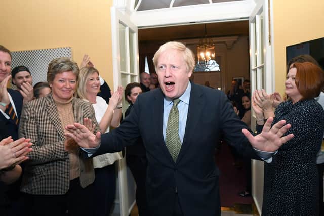 Prime Minister Boris Johnson is greeted by staff as he arrives back at 10 Downing Street, London, after meeting Queen Elizabeth II and accepting her invitation to form a new government after the Conservative Party was returned to power in the 2019 General Election with an increased majority. Photo: Stefan Rousseau/PA Wire