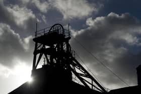 The sun shines behind the headframe of a shaft mine at the National Coal Mining Museum based on the site of the former Caphouse Colliery in Overton, near Wakefield. Photo: OLI SCARFF/AFP via Getty Images)