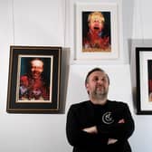 Craig Humble in front of the artwork by WeFail