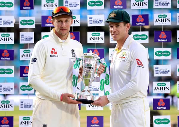England Captain Joe Root (left) and Australia Captain Tim Paine hold the trophy on stage during the final presentation at the end of day four of the fifth test match at The Kia Oval, London. (Picture: PA)