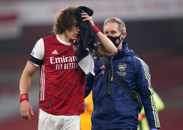David Luiz is led off the field with a head injury (Picture: PA)