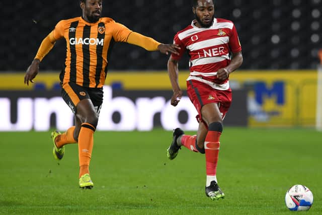 Rovers Cameron John dribbles awy from Hull's Hakeeb Adelakun  (Picture: Howard Roe/AHPix)
