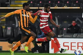 Doncaster's Cameron John battles with Hull's Hakeeb Adelakun (Picture: Howard Roe/AHPix)