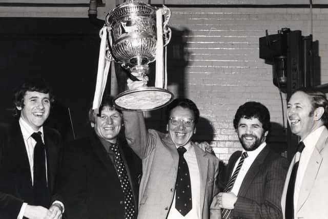 Early days: John Morgan holds the rugby league Challenge Cup aloft watched by, from left, a youthful Harry Gration, Peter Fox, David Watkins and David Coleman.