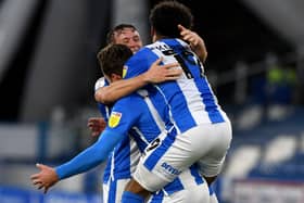 Get in: Harry Toffolo, of Huddersfield Town, is mobbed by team-mates after scoring the second goal. Picture: James Hardisty