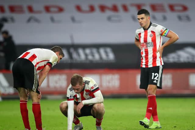 Blades duo Oli McBurnie and John Egan  look on dejected at the final whistle. Picture: Simon Bellis/Sportimage