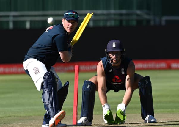 Heading home: England captain Eoin Morgan plays a shot as wicketkeeper Jos Buttler looks on during a net session. Picture: Shaun Botterill/Getty Images