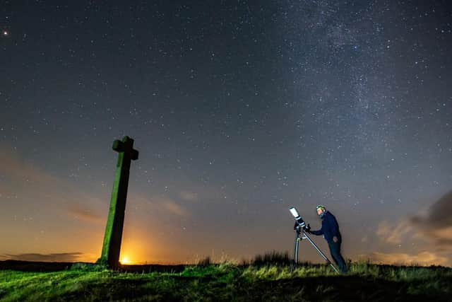 Richard Darn surveys the night sky as the moon sets at Ralphs Cross, Westerdale, on the North York Moors