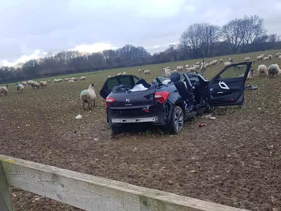 The car overshot a junction, flew across an embankement, over a fence and into a field