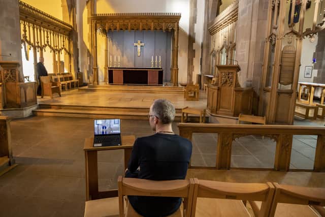 A church parishoner watches an online service during lockdown.