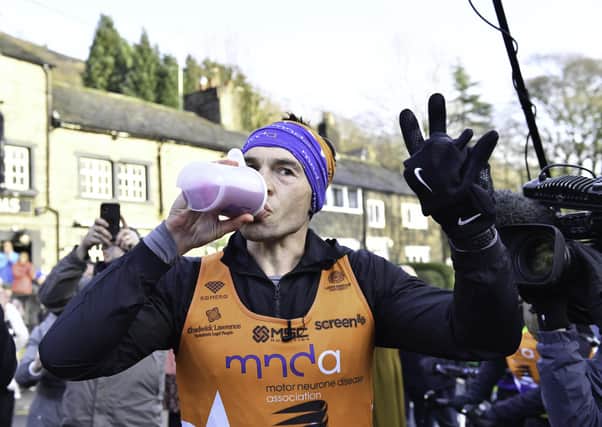 Well-earned drink: Kevin Sinfield as he completed his final marathon. Picture: Simon Wilkinson/SWpix