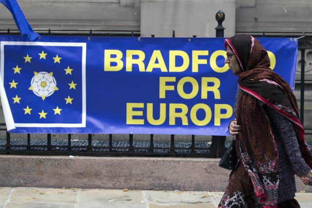 A woman passes by a Bradford for Europe banner. Picture: Jim Brogden