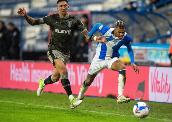 Liam Palmer and Juninho Bacuna chase down the line as Huddersfield Town defeated Sheffield Wednesday (Picture: Bruce Rollinson)