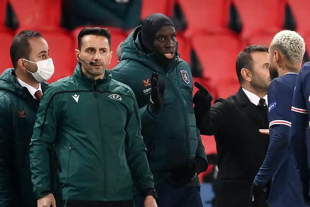 Romanian fourth official Sebastian Coltescu (second left) looks on next to Istanbul Basaksehir forward Demba Ba (second right) and Paris Saint-Germain's Neymar (right) during the UEFA Champions League Group H clash at Parc des Princes.