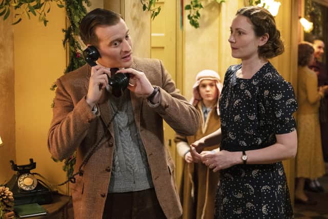James (Nicholas Ralph) takes a call while Mrs Hall (Anna Madeley) looks on. She is wearing her best dress, a printed style that typifies the 1930s. Images courtesy of Channel 5 and Playground Entertainment.