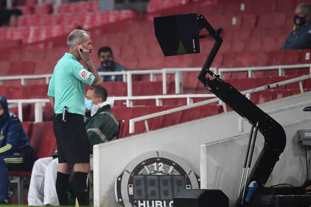 Referee Martin Atkinson consults VAR during a match between Arsenal and Aston Villa at the Emirates Stadium. Picture: Andy Rain/PA
