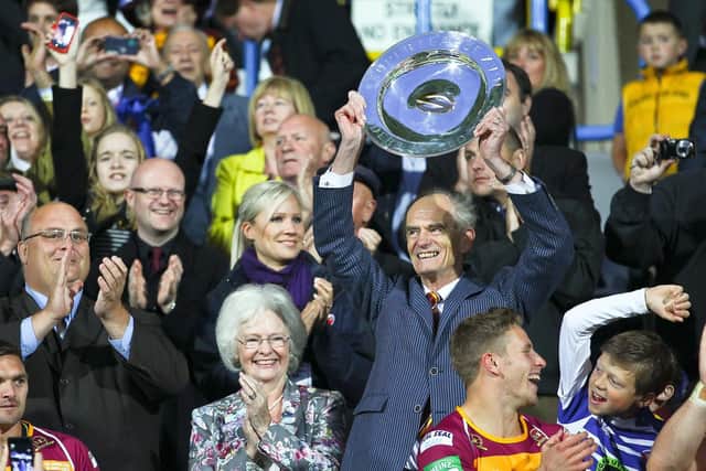 MAGIC MOMENT: Ken Davy lifts the League Leaders’ Shield back in 2013, with his late, beloved wife Jennifer by his side. The Yorkshireman took over Huddersfield Giants back in 2006. Picture: Alex Whitehead/SWPIX.com