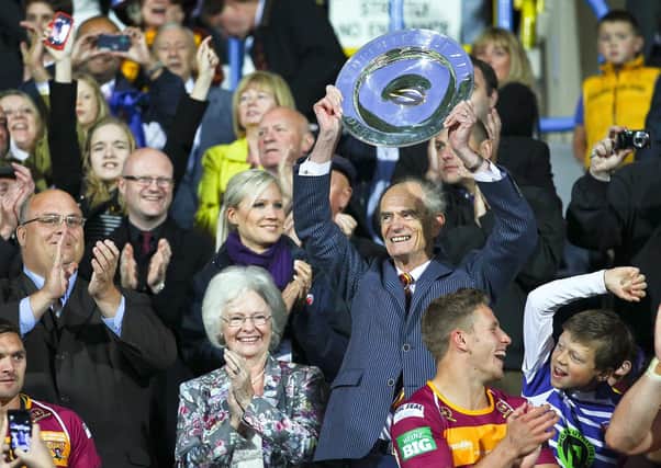 MAGIC MOMENT: Ken Davy lifts the League Leaders’ Shield back in 2013, with his late, beloved wife Jennifer by his side. The Yorkshireman took over Huddersfield Giants back in 2006. Picture: Alex Whitehead/SWPIX.com