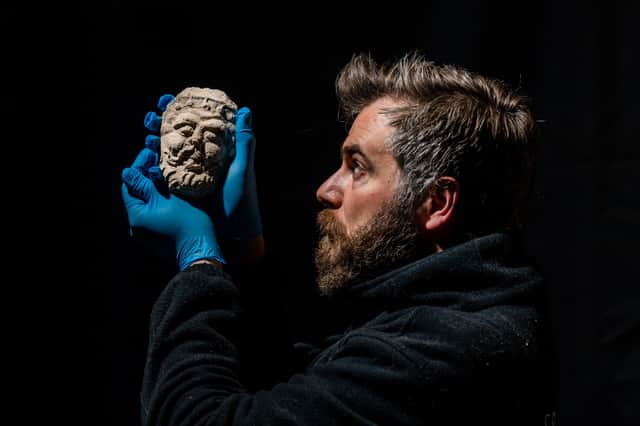 Richard Mason, Curator of Collections and Interiors for English Heritage, holding a plaster moulding face from a ceiling rose at Edlingham Castle. Picture: James Hardisty
