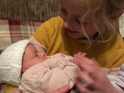 Videos from the hospital helped big sister Freya bond with little Riley