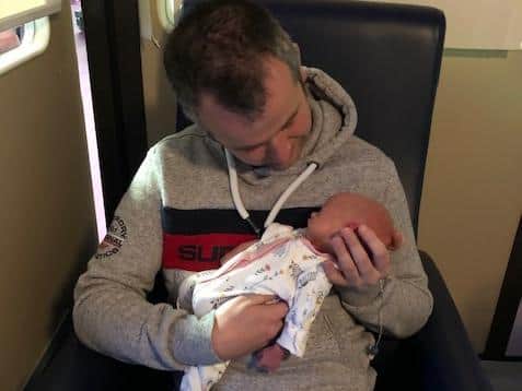 Dad Mark was finally able to hold Riley after two weeks of self-isolation