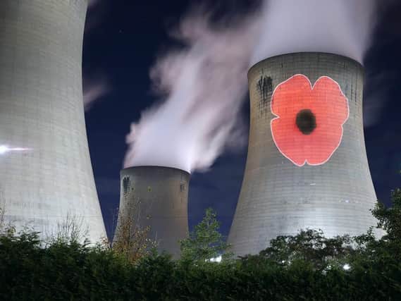 A poppy projected onto a cooling tower at Drax Power Station for Remembrance Sunday