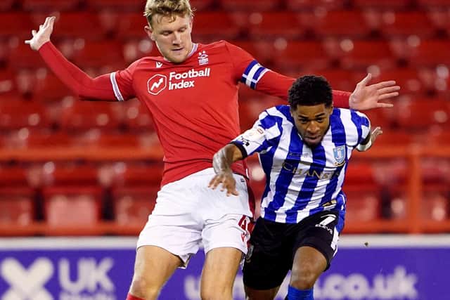 Nottingham Forest's Joe Worrall (left) and Sheffield Wednesday's Kadeem Harris battle for the ball. Picture: PA