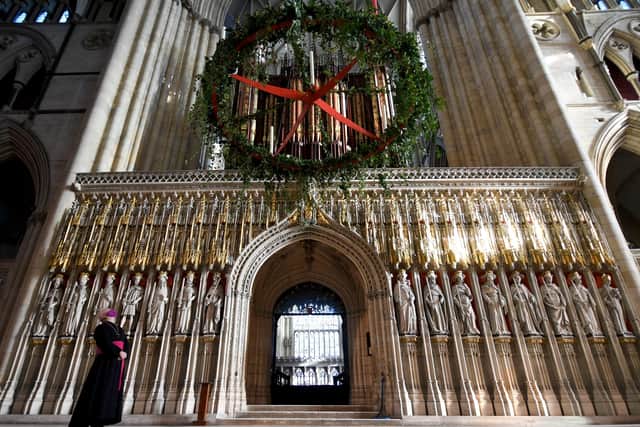The Archbishop of York surveys the giant wreath at York Minster this Christmas.