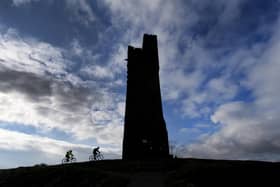 Cyclists are pictured riding up to Castle Hill, Huddersfield. Technical details: Nikon D5, 12-24mm lens, exposure 320th sec at f11, iso 200. Picture: Simon Hulme