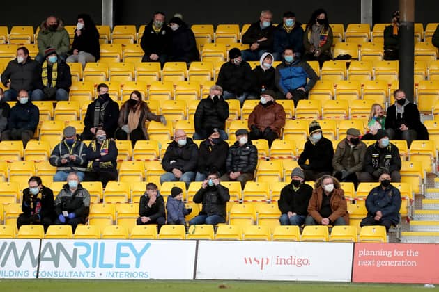 Fans pictured socially distancing at Harrogate Town's EnviroVent Stadium. Picture: Richard Sellers/PA