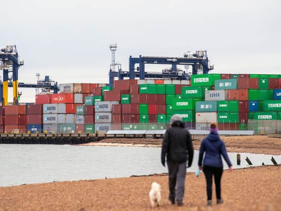 Shipping containers are unloaded from a cargo ship at the Port of Felixstowe in Suffolk. Picture: Joe Giddens/PA Wire.