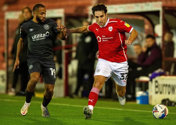 Happy at Oakwell: Matty James holds off Brentford's Bryan Mbeumo.  Picture: Bruce Rollinson